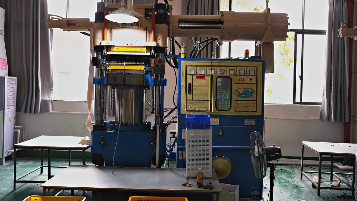 A rubber vulcanising press inside Geoleap's own golf grip factory — the kind of plant most grip brands contract out to