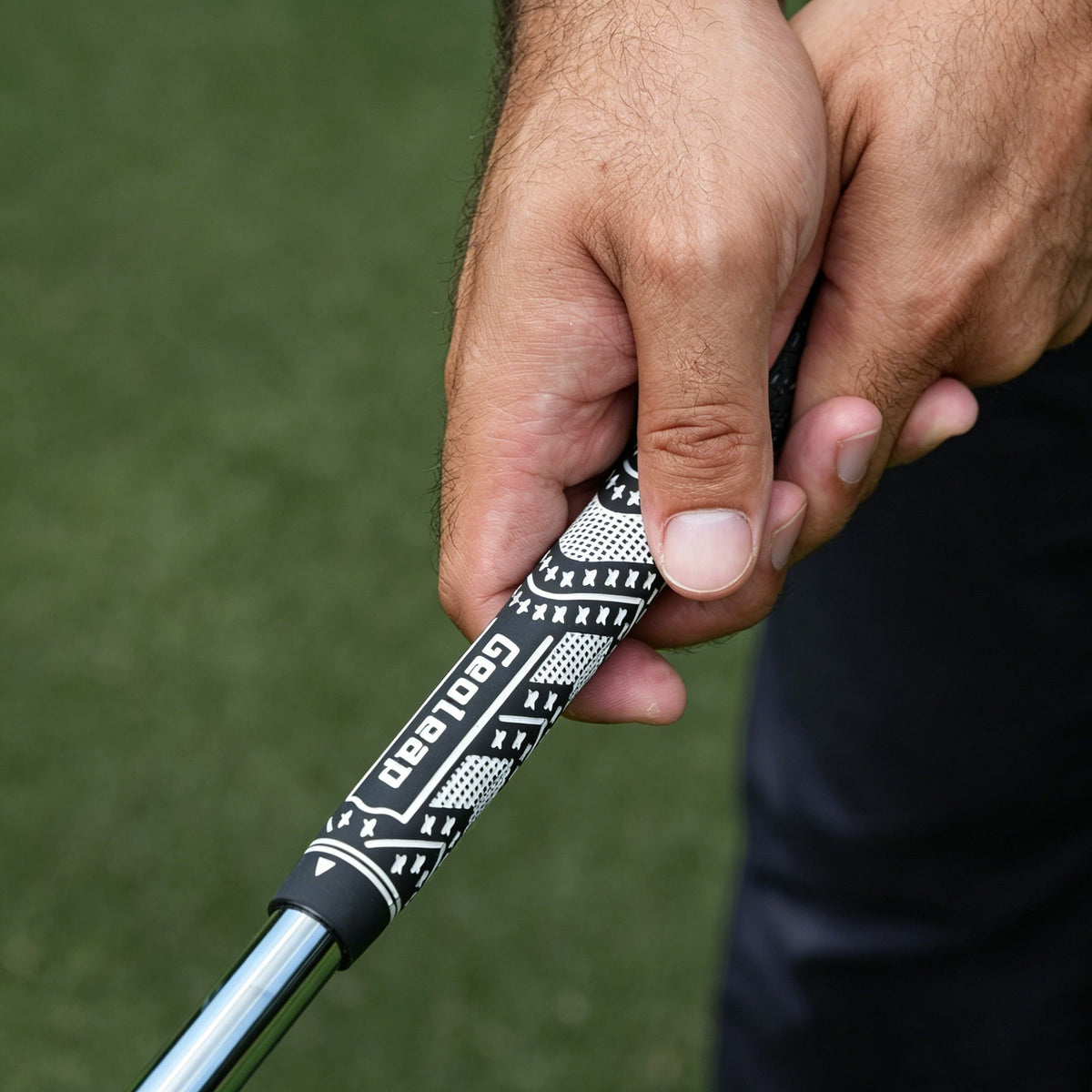 Close-up of a hand on a Geoleap corded golf grip — checking grip wear